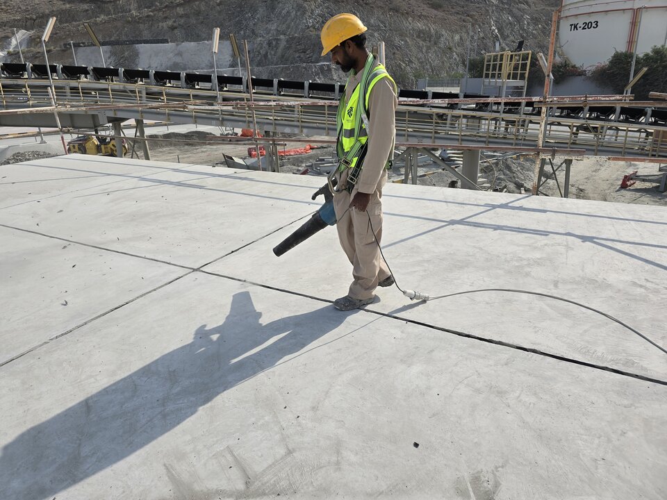 Worker carrying out waterproofing work on an exposed roof
