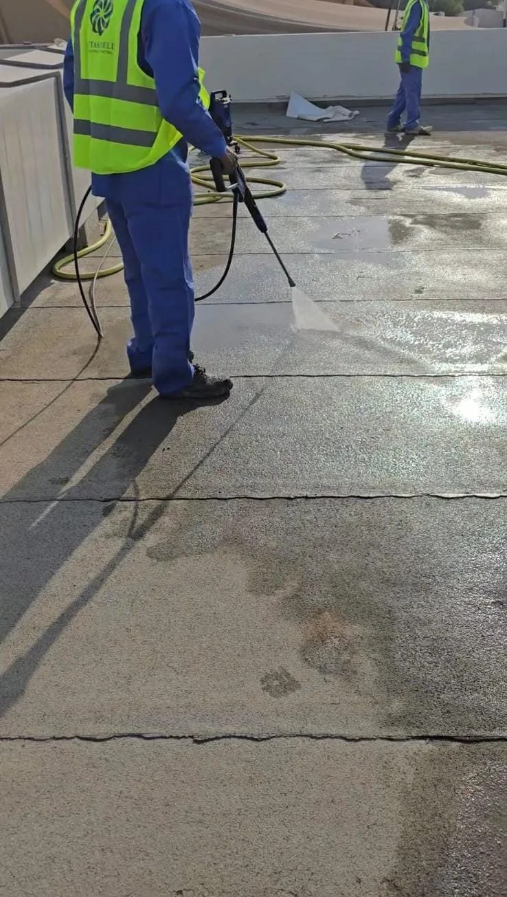Worker carrying out roof surface work beside a joint